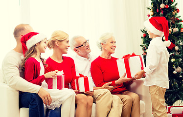 Image showing smiling family with gifts at home