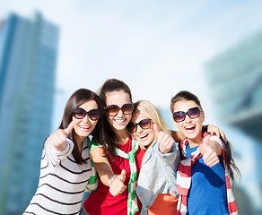 Image showing happy teenage girls showing thumbs up at city