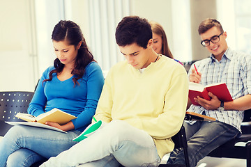 Image showing group of smiling students with notebooks