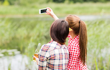 Image showing happy women taking selfie by smartphone outdoors