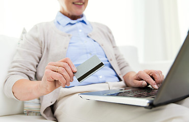 Image showing senior woman with laptop and credit card at home