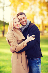 Image showing smiling couple hugging in autumn park