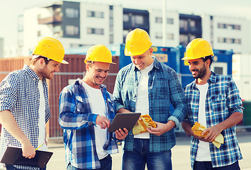 Image showing group of smiling builders with tablet pc outdoors