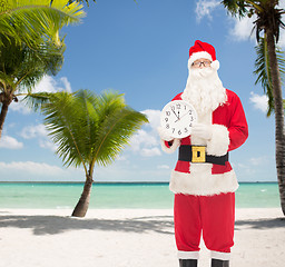 Image showing man in costume of santa claus with clock