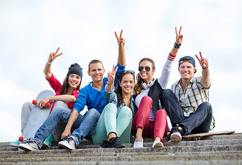 Image showing group of teenagers showing finger five