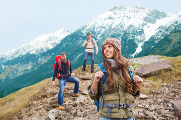 Image showing group of smiling friends with backpacks hiking