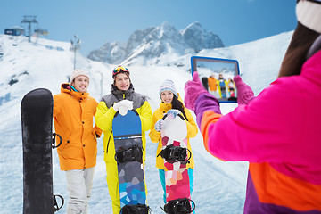 Image showing happy friends with snowboards and tablet pc