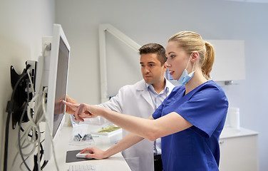 Image showing dentists with x-ray on monitor at dental clinic