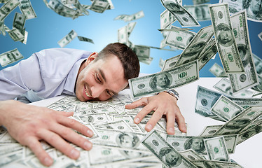 Image showing happy businessman with heap of money