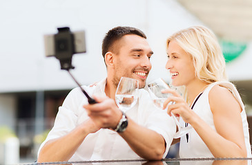 Image showing happy couple taking selfie with smartphone at cafe