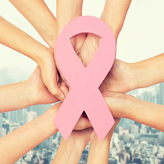 Image showing close up of hands with cancer awareness symbol