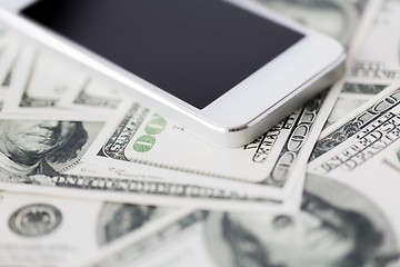 Image showing close up of smartphone and dollar money