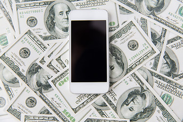 Image showing close up of smartphone and dollar money