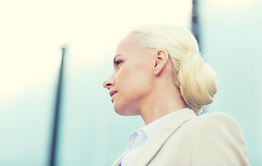 Image showing young businesswoman over office building