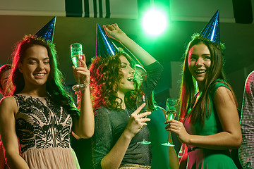 Image showing smiling friends with glasses of champagne in club