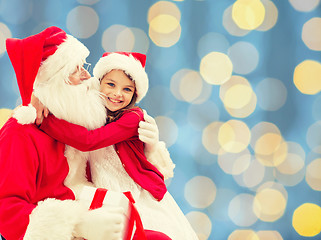 Image showing smiling little girl with santa claus