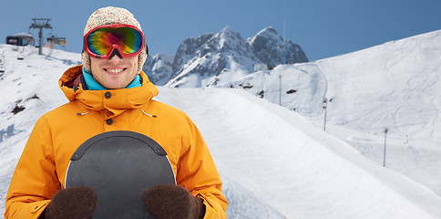 Image showing happy young man in ski goggles over mountains