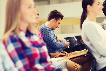 Image showing group of smiling students in lecture hall