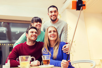 Image showing group of friends taking selfie with smartphone