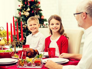 Image showing smiling family having holiday dinner at home