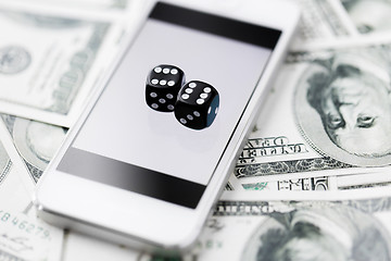 Image showing close up of dice with smart phone and cash money