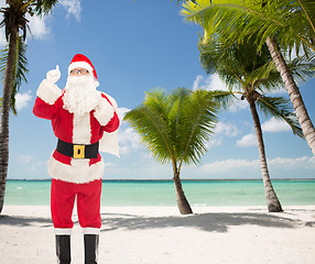 Image showing man in costume of santa claus pointing finger up