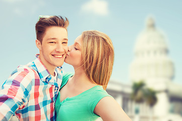 Image showing couple kissing and taking selfie over white house