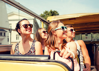 Image showing group of smiling friends traveling by tour bus