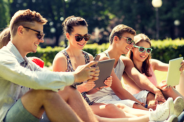 Image showing smiling friends with tablet pc computers in park