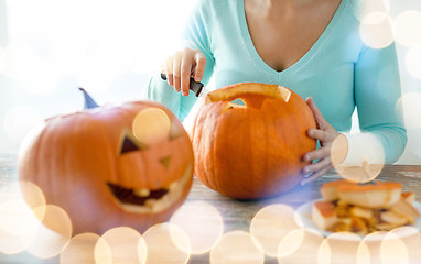 Image showing close up of woman with pumpkins at home