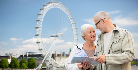 Image showing senior couple with map talking over london