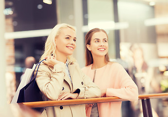 Image showing happy young women with shopping bags in mall