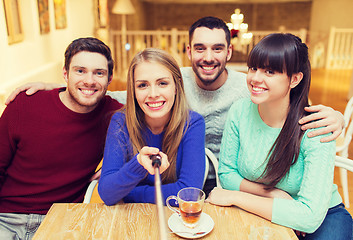 Image showing group of friends taking picture with selfie stick