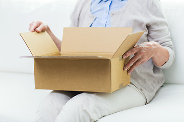 Image showing close up of senior woman with parcel box at home