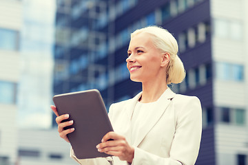 Image showing smiling businesswoman with tablet pc outdoors
