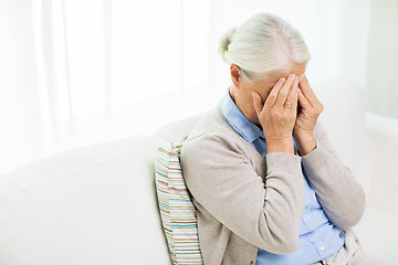 Image showing senior woman suffering from headache or grief