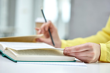 Image showing close up of female hands to book or textbook