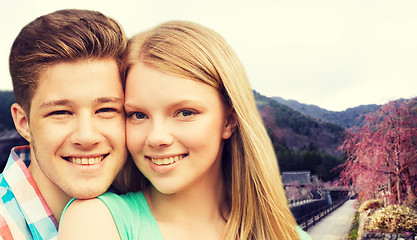 Image showing smiling couple over asian landscape background