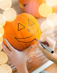 Image showing close up of woman with pumpkins at home