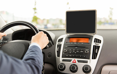 Image showing close up of young man with tablet pc driving car