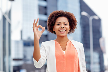 Image showing happy african businesswoman showing ok in city