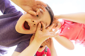 Image showing group of kids having fun and making faces outdoors