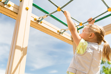 Image showing close up of girl climbing on children playground