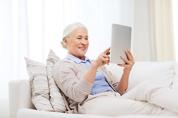 Image showing happy senior woman with tablet pc at home