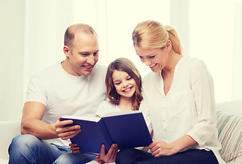 Image showing smiling parents and little girl with at home