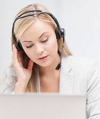 Image showing female helpline operator with laptop