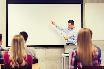 Image showing group of students and teacher with notepad