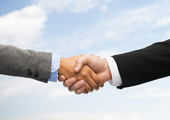 Image showing businessman and businesswoman shaking hands