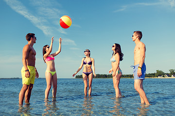 Image showing smiling friends in sunglasses on summer beach