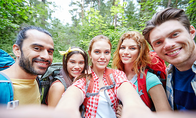 Image showing friends with backpack taking selfie in wood